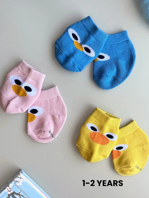Air Garb brand baby combo socks for infants; a 6-pair set of soft cotton socks featuring pineapple, watermelon, cherry, and cute character face designs in vibrant colors like yellow, red, and blue.