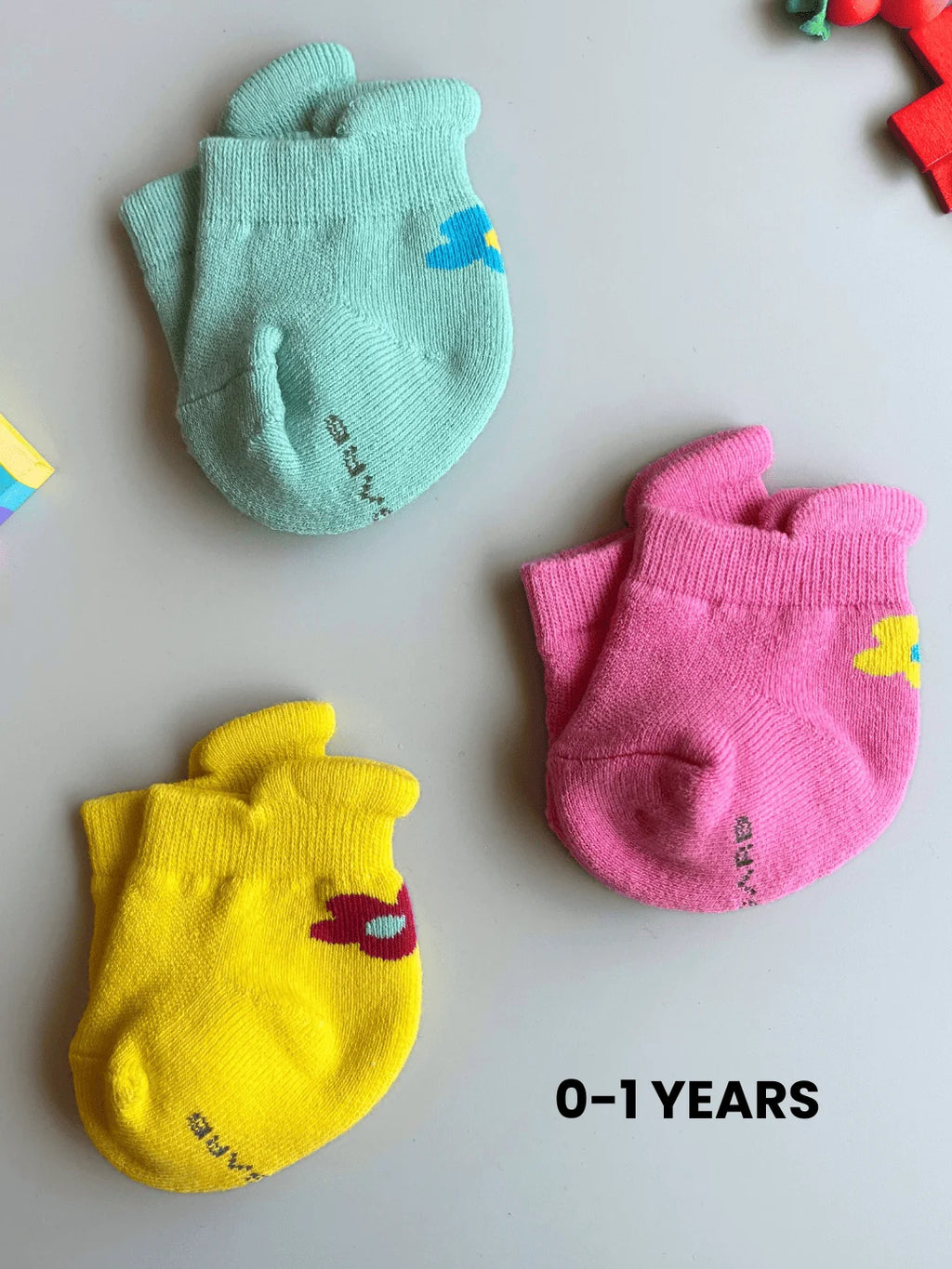 Air Garb baby combo socks for infants 0-1 years; a 6-pair collection of soft cotton socks featuring pink owl, brown giraffe, white puppy, and colorful flower designs in mint, yellow, and pink.